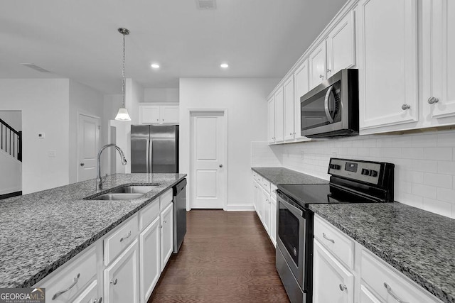 kitchen with tasteful backsplash, a sink, dark wood-style floors, white cabinetry, and stainless steel appliances