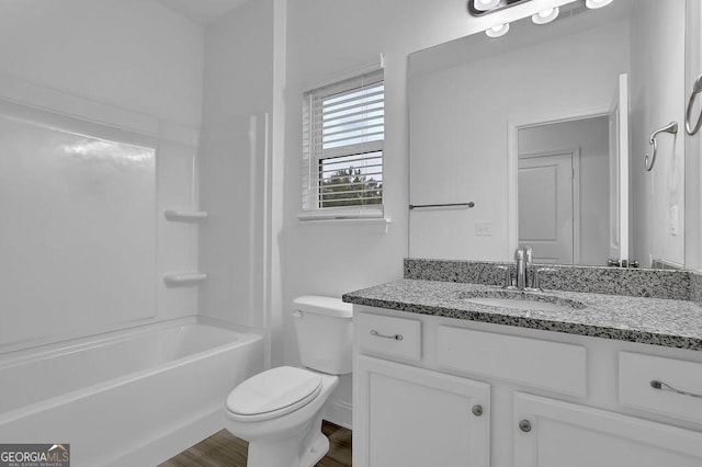 full bathroom featuring toilet, wood finished floors, and vanity