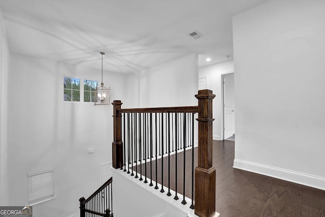 stairway featuring visible vents, baseboards, an inviting chandelier, recessed lighting, and wood finished floors