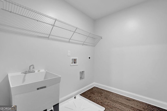clothes washing area with baseboards, washer hookup, a sink, laundry area, and hookup for an electric dryer