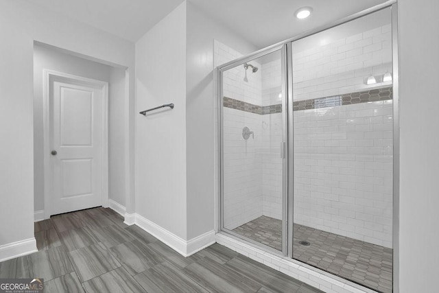 full bath with baseboards and a stall shower