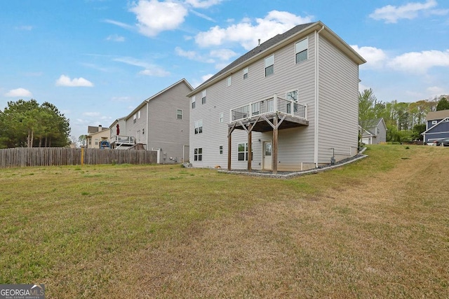 back of property with a yard and fence