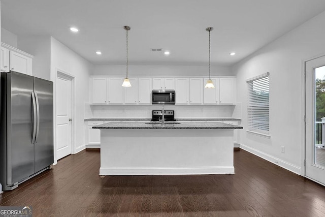 kitchen featuring dark wood-type flooring, visible vents, white cabinets, dark stone countertops, and appliances with stainless steel finishes