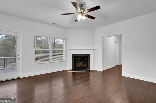 unfurnished living room featuring a glass covered fireplace, wood-type flooring, a ceiling fan, and visible vents