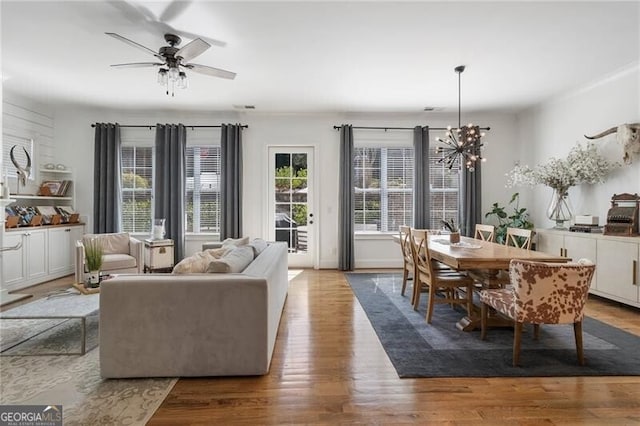 557 Stone Field Run NW, Marietta, GA 30060 - living room with ceiling fan with notable chandelier and wood finished floors