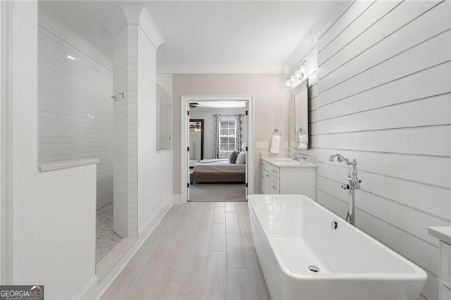 557 Stone Field Run NW, Marietta, GA 30060 - ensuite bathroom with connected bathroom, a walk in shower, vanity, a soaking tub, and baseboards