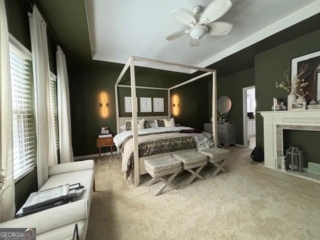 5225 Tye Trl, Fairburn, GA 30213 - carpeted bedroom featuring ceiling fan and a fireplace