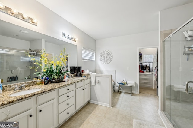 5225 Tye Trl, Fairburn, GA 30213 - full bathroom with double vanity, a shower stall, a walk in closet, and tile patterned flooring