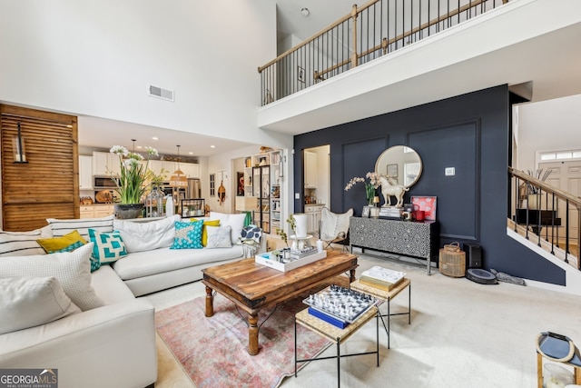 5225 Tye Trl, Fairburn, GA 30213 - living area with a towering ceiling, stairway, and light colored carpet