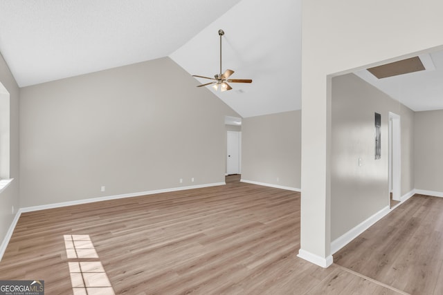 unfurnished living room featuring high vaulted ceiling, light wood finished floors, a ceiling fan, and baseboards