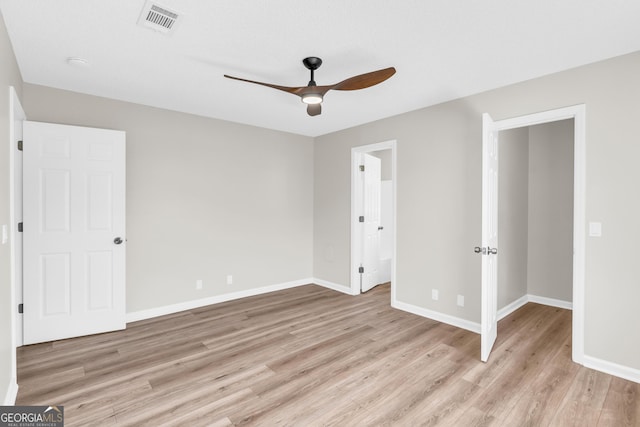 unfurnished bedroom featuring visible vents, light wood finished floors, baseboards, and a ceiling fan