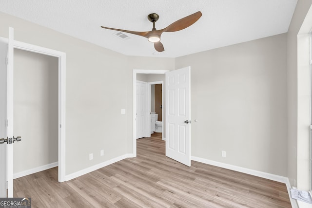 unfurnished bedroom featuring visible vents, light wood finished floors, baseboards, and ceiling fan
