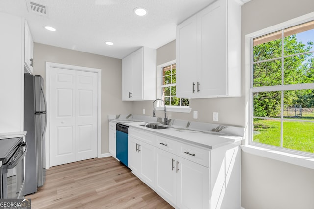 kitchen featuring light countertops, visible vents, a sink, and appliances with stainless steel finishes