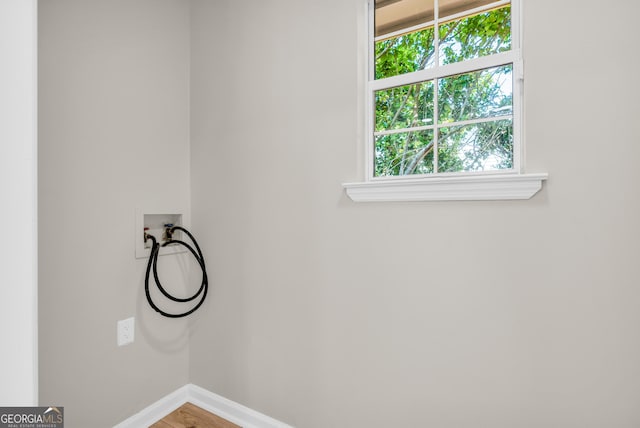 laundry room with wood finished floors, baseboards, laundry area, and washer hookup