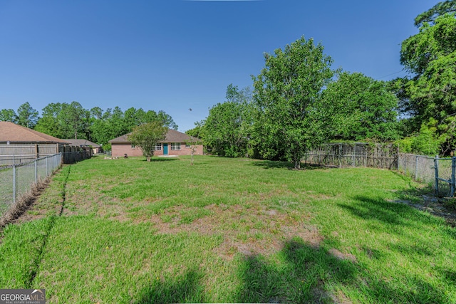 view of yard with a fenced backyard