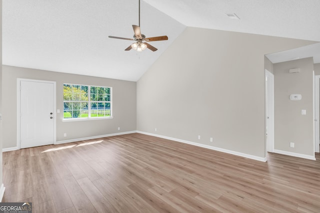 unfurnished living room featuring baseboards, vaulted ceiling, light wood-style flooring, and ceiling fan