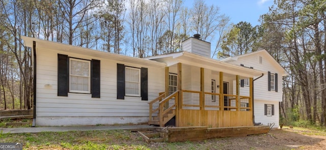 140 Elberta Dr, Newnan, GA 30265 - view of front facade featuring a chimney and covered porch