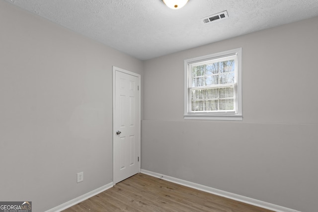 140 Elberta Dr, Newnan, GA 30265 - unfurnished room featuring wood finished floors, baseboards, and a textured ceiling