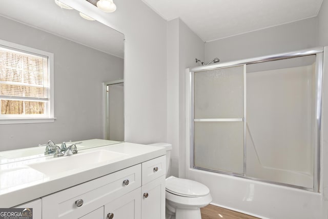 140 Elberta Dr, Newnan, GA 30265 - full bathroom with vanity, toilet, combined bath / shower with glass door, and wood finished floors