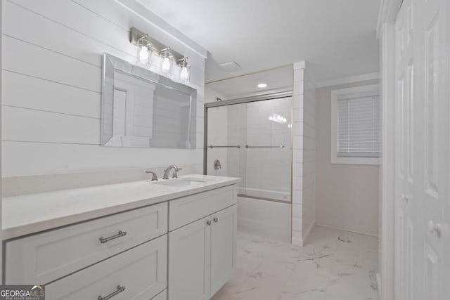 full bath with marble finish floor, vanity, and combined bath / shower with glass door