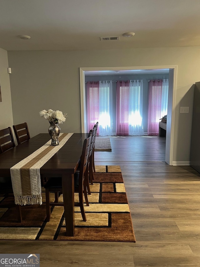 1815 Old Salem Rd SE, Conyers, GA 30013 - dining area featuring baseboards, visible vents, and wood finished floors