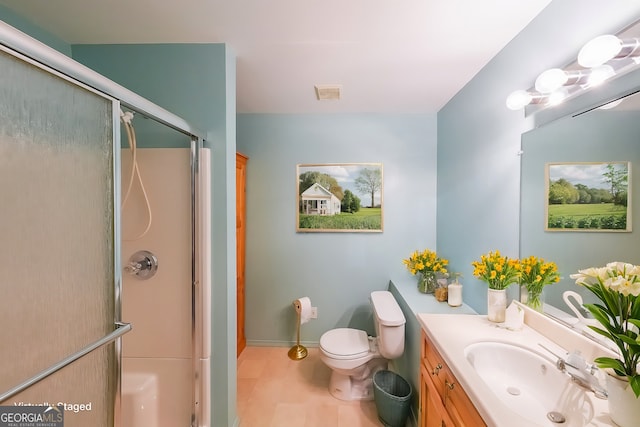 full bathroom featuring a stall shower, vanity, toilet, and baseboards