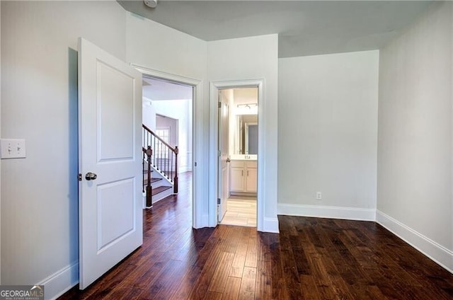 unfurnished bedroom with baseboards and wood finished floors