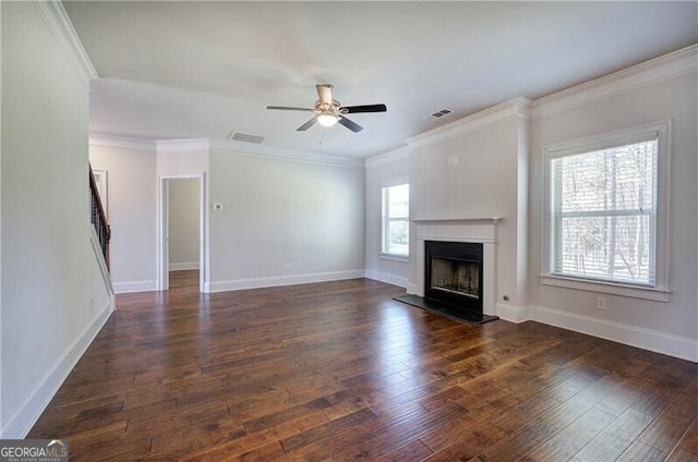 unfurnished living room featuring a ceiling fan, visible vents, a fireplace with raised hearth, and dark wood finished floors