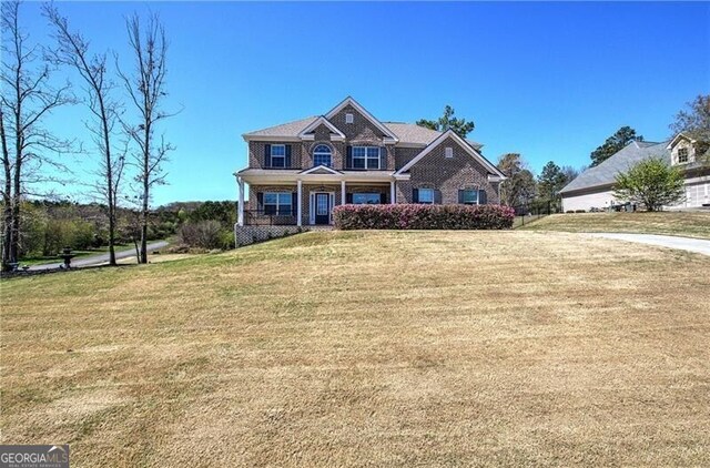 craftsman house featuring a front lawn and a porch