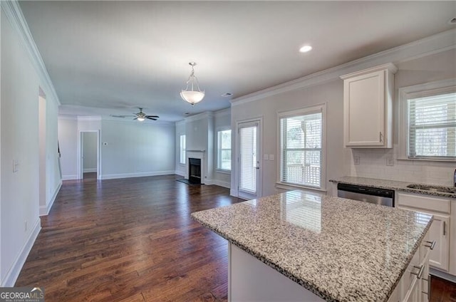 106 Lighthouse Cv SW, Adairsville, GA 30103 - kitchen with a fireplace, dishwasher, ornamental molding, white cabinets, and a kitchen island