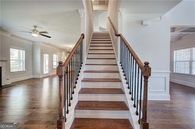 stairway featuring a ceiling fan, wood finished floors, beam ceiling, and ornamental molding