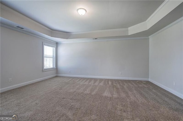unfurnished room featuring a tray ceiling, visible vents, ornamental molding, carpet floors, and baseboards