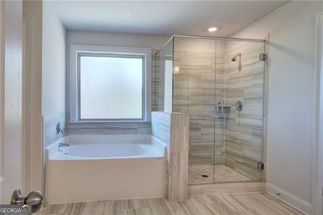 full bath with a garden tub and a stall shower