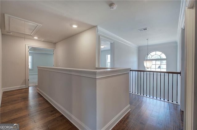 corridor featuring attic access, baseboards, visible vents, and dark wood-style floors