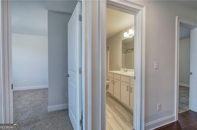 full bathroom featuring baseboards, walk in shower, and vanity