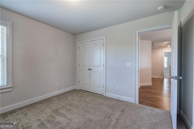 106 Lighthouse Cv SW, Adairsville, GA 30103 - unfurnished bedroom featuring carpet floors, attic access, and a closet