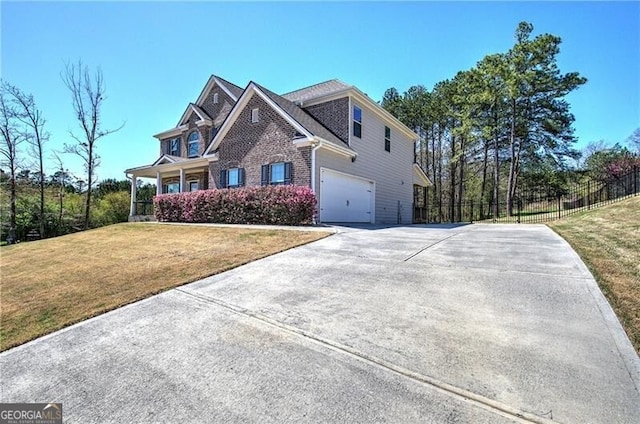view of property exterior featuring driveway, fence, brick siding, an attached garage, and a lawn