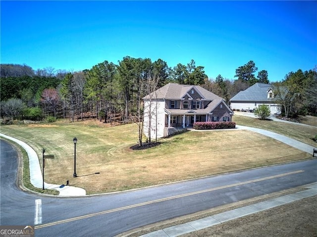 view of front of property with driveway and a front lawn
