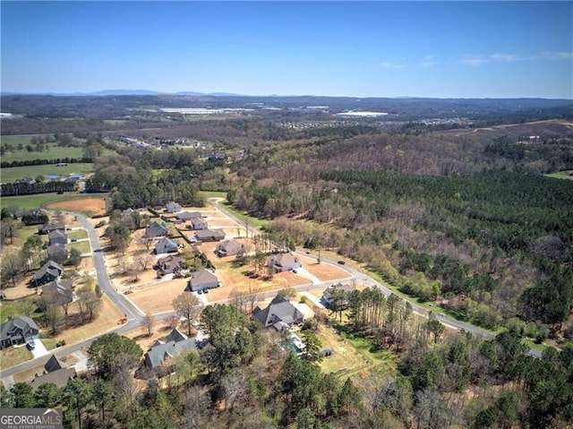 drone / aerial view with a wooded view