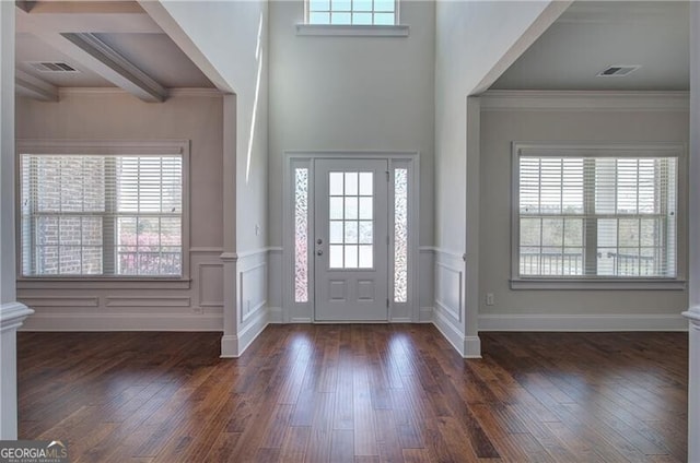 entrance foyer with plenty of natural light, visible vents, and decorative columns