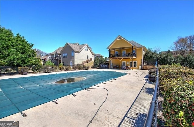 pool featuring a residential view, a patio area, and fence