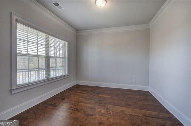 spare room with baseboards, visible vents, crown molding, and dark wood-style floors