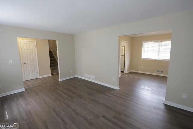 4183 Northstrand Dr, Decatur, GA 30035 - unfurnished room featuring baseboards, visible vents, stairway, and dark wood finished floors