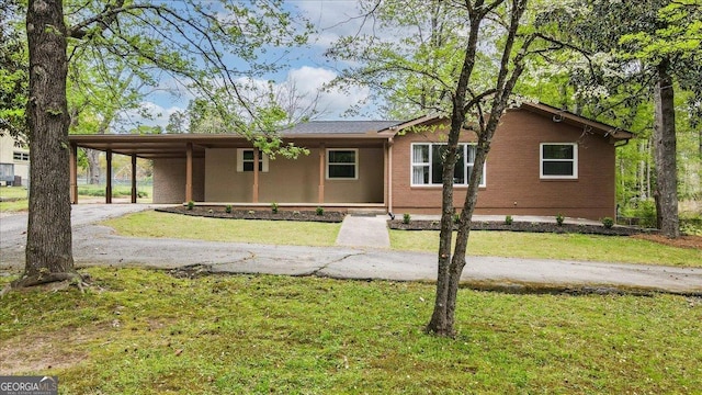 3951 Covered Bridge Rd SW, Smyrna, GA 30082 - ranch-style home featuring a front lawn, a carport, and driveway