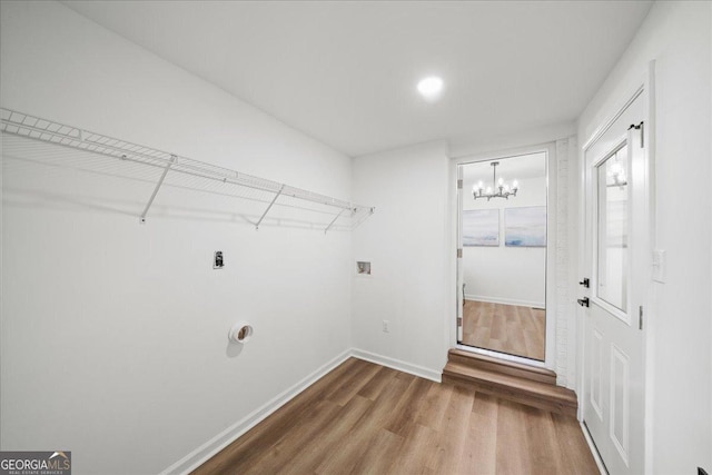 3951 Covered Bridge Rd SW, Smyrna, GA 30082 - laundry room featuring wood finished floors, a chandelier, baseboards, and washer hookup
