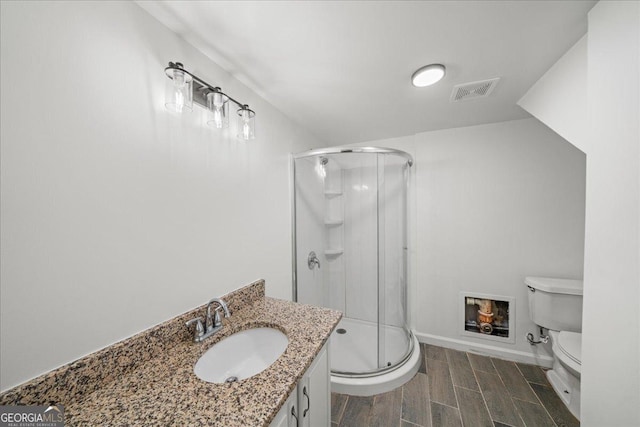 3951 Covered Bridge Rd SW, Smyrna, GA 30082 - full bathroom with toilet, a shower stall, vanity, and wood tiled floors