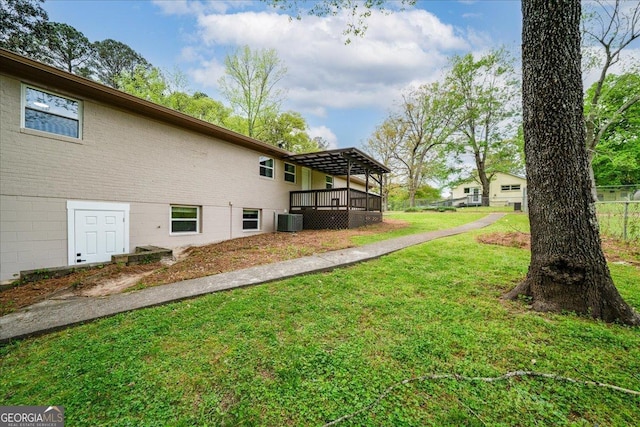 3951 Covered Bridge Rd SW, Smyrna, GA 30082 - view of green lawn featuring central air condition unit and a deck