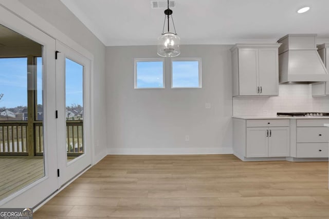 unfurnished dining area featuring recessed lighting, baseboards, light wood finished floors, visible vents, and a notable chandelier