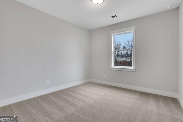 carpeted empty room with baseboards and visible vents