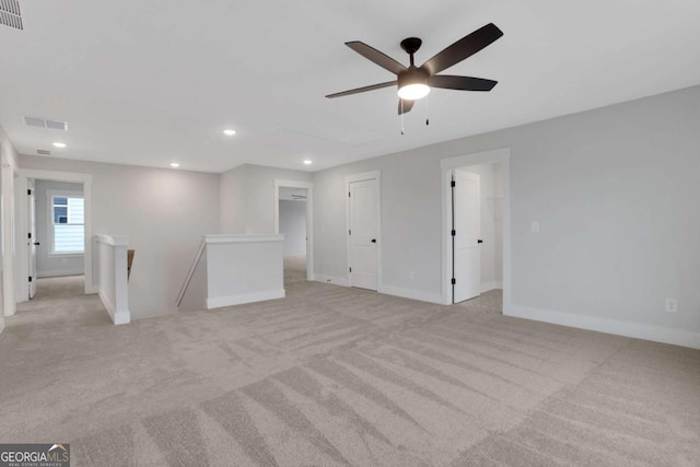 unfurnished room with light colored carpet, visible vents, ceiling fan, and recessed lighting